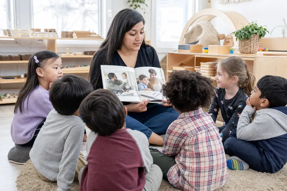 Preschool children listening to an inclusive picture book at daycare