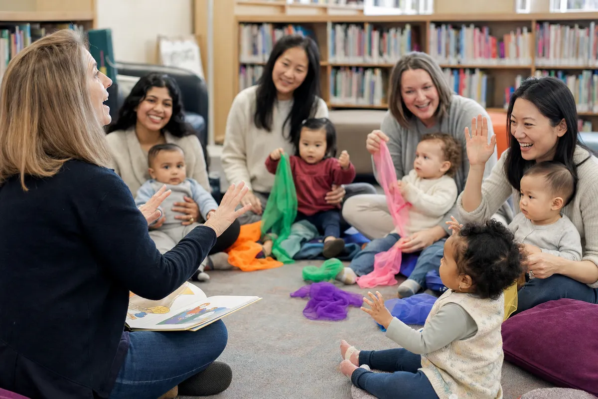 Caregivers and young children participating in a library rhyme time
