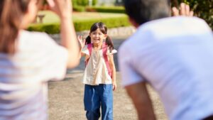 A happy family excitedly waving hands, symbolizing a positive back to daycare experience for everyone.