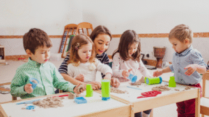 Children enthusiastically playing with toys in a colorful classroom, showcasing the interactive nature of early childhood education.