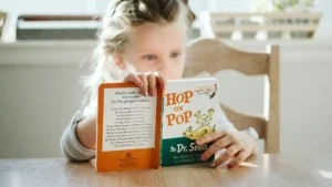 Child reading a picture book before kindergarten