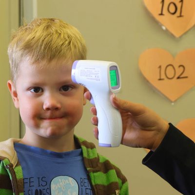A young child arriving at the Clever Day Care Centre in Calgary gets his tempearture taken with this portal scanning gun. All children are scanned in the morning before heading to class to keep the facility Covid-19 free.