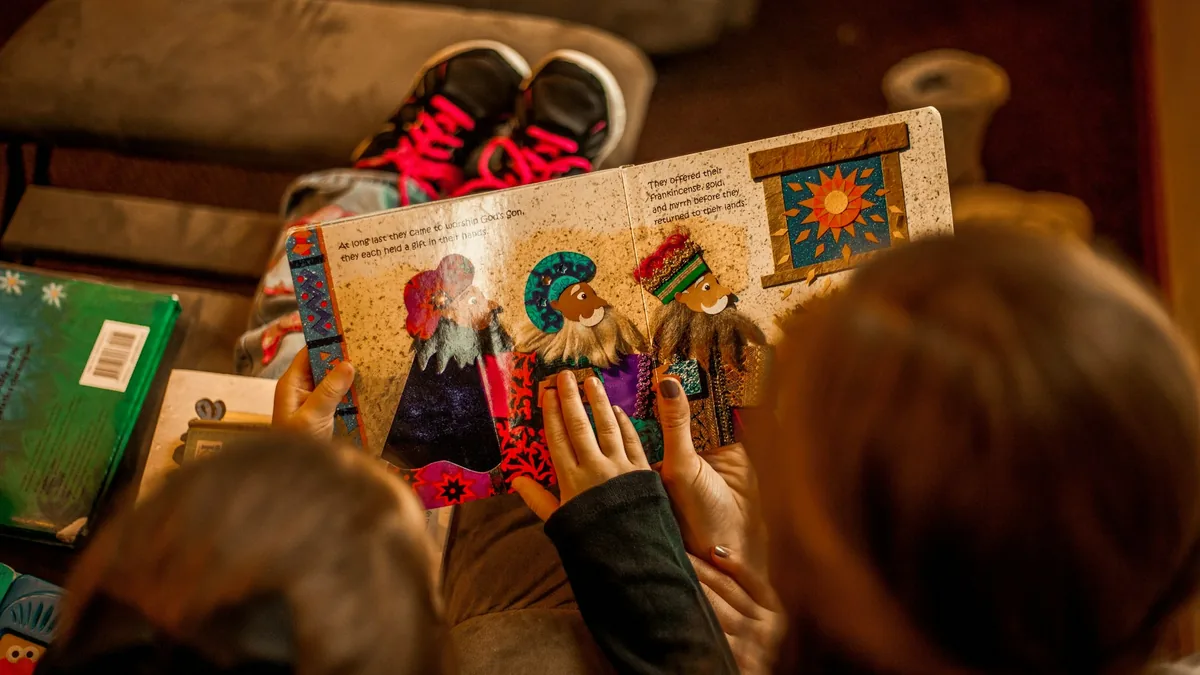 Children sharing a picture book during play-based learning